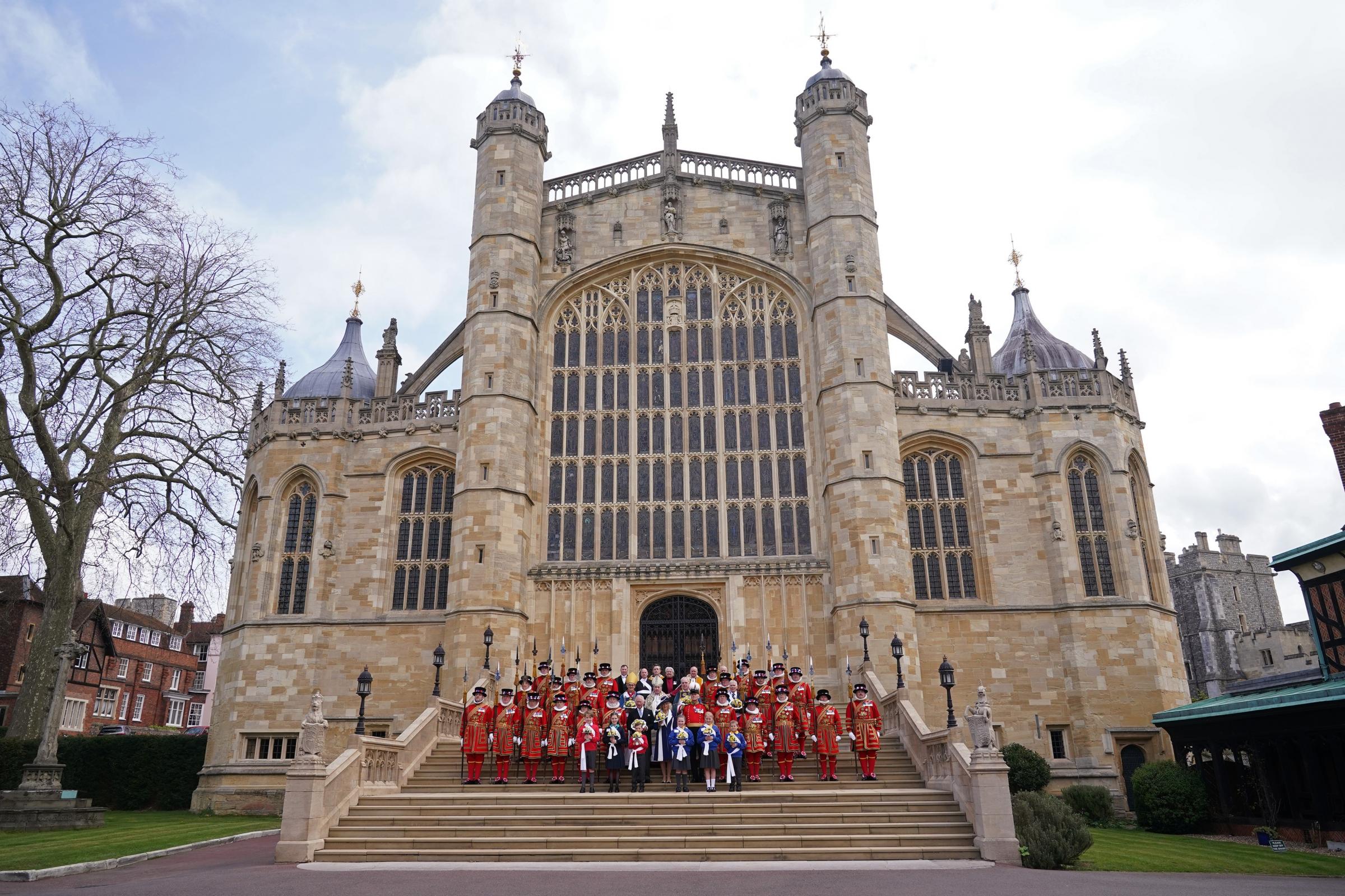 The Prince of Wales, representing the Queen and the Duchess of Cornwall, (both centre front) pose for a group photograph with members of the Queens Body Guard of the Yeomen of the Guard, following the Royal Maundy Service at St Georges Chapel,